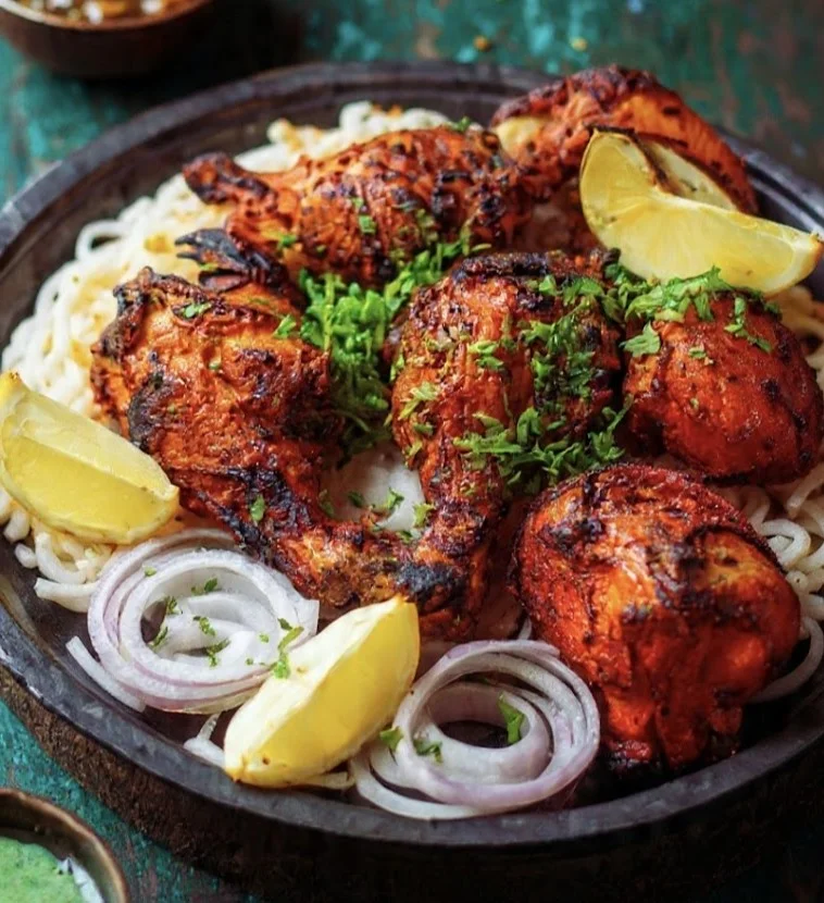 Tandoori chicken platter with lemon and onion rings at Chandigarh Curry House Calgary